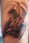 horror arm tattoo